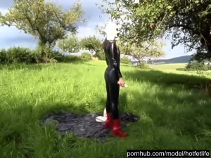 Rubber Girl Full in Black Latex Catsuit and Mask Plays with herself Outdoor in a Meadow - Part 3