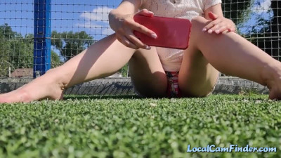 Pregnant Russian babe masturbates in public football court